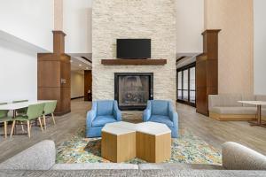a lobby with a living room with a fireplace at Hampton Inn & Suites Bend in Bend