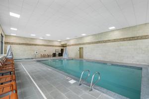 a large swimming pool with blue water in a building at Hampton Inn & Suites Bend in Bend