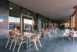 eine Reihe von Tischen und Stühlen in einem Restaurant in der Unterkunft Hotel Ruta de Europa in Vitoria-Gasteiz