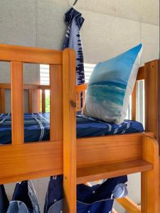 a bunk bed with a pillow on top of it at Du Mục in Thôn Mỹ Phước