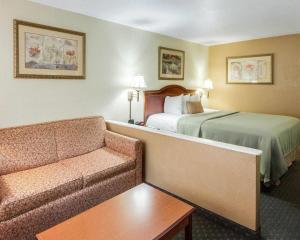 a hotel room with a bed and a couch at Econo Lodge Inn & Suites Eagle Pass in Eagle Pass +13 photos