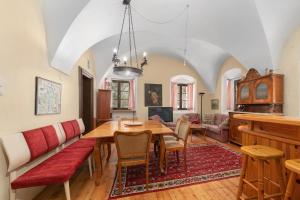 a dining room with a table and a couch at Schloss Berg Klösterle in Zedlitzdorf