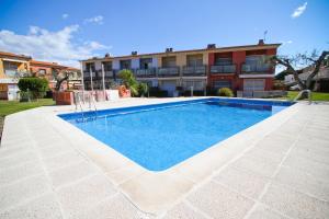 a swimming pool in front of a building at Olivers Planet Costa Dorada in Cambrils