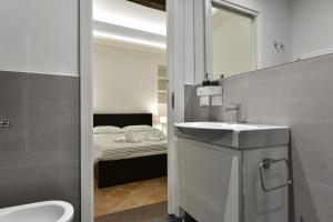 a bathroom with a sink and a bedroom with a bed at Campo de' Fiori Brand New Apartment in Rome