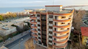 an apartment building with balconies on a city street at Samali Residence in Eforie Nord