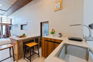 a kitchen with a sink and a counter top at Kaafal Cottage in Mukteshwar