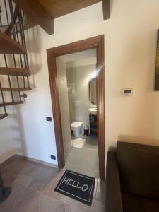 a hallway with a door to a bathroom with a toilet at La villetta tra ulivi e colline in Civezza +13 photos