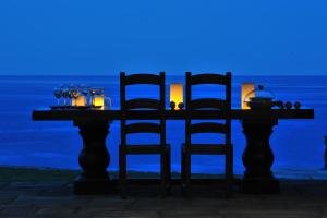 a table with two chairs and a candle on it at Aegea Blue Cycladic Resort in Zorgos 