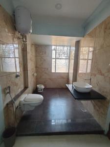 a bathroom with two toilets and a sink in it at Oasis Fun Villa - Cafe in Rao