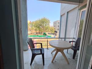 a patio with a table and chairs on a balcony at Oasis Fun Villa - Cafe in Rao