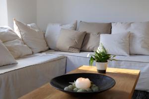 a table with a candle and a couch at Aegea Blue Cycladic Resort in Zorgos 