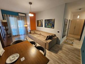 a living room with a couch and a table at central apart in Tirana