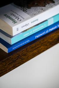 a stack of books sitting on a table at To Pelagos in Agios Sostis