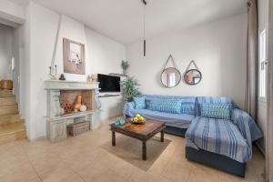 a living room with a couch and a table at To Pelagos in Agios Sostis