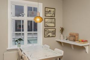 a dining room with a table and a window at Grettir Guesthouse Downtown Charm in Reykjavík +18 photos
