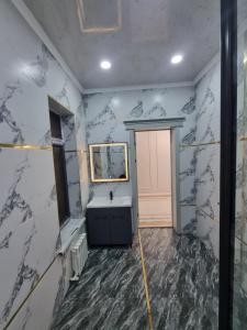 a bathroom with a sink and a mirror at Самал 3 in Shymkent