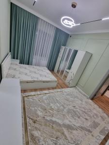 an empty room with two beds in it at Самал 3 in Shymkent +9 photos