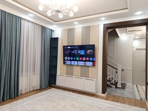 a living room with a flat screen tv on a wall at Самал 3 in Shymkent