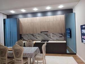 a kitchen with a table and chairs and a counter at Самал 3 in Shymkent