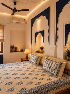 a bedroom with a bed with two pillows on it at Garh Harsolav in Harsolāv +2 photos