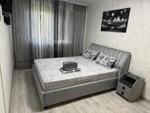 a bedroom with a bed and a tv in it at AeroHome Moldova- TAXI-PARKING ! in Chişinău