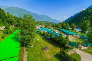 an aerial view of a resort in the mountains at The Himalayan Swiss Cottage with Bonfire, Manali - A Riverside Retreat in Manāli