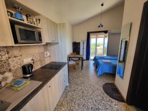 a kitchen with a counter and a living room at Filippos Apartments "Room 6" in Spartià