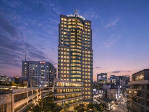 a tall building with a sign on the top of it at Orakai Insadong Suites in Seoul