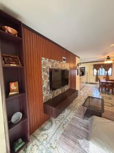 a living room with a fire place in a wall at Linas Lodge in Vaitele