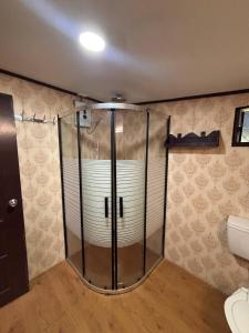 a glass shower in a bathroom with a toilet at Linas Lodge in Vaitele +28 photos