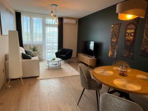a living room with a table and a couch at K&T Apartman in Szentendre +8 photos