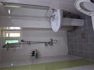 a bathroom with a toilet and a sink at Gyeongsan Annex Pension in Gyeongsan