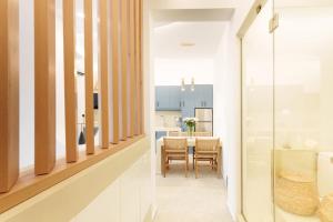 a dining room and kitchen with a table and chairs at ARTEMIS SUITE in Agia Marina +89 photos