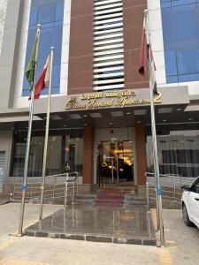 a building with three flags in front of it at دانة الرياض للشقق المخدومة2 - Dana Serviced Apartments2 in Riyadh