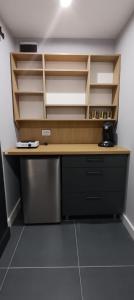 a kitchen with a desk and shelves in a room at Central Studio Abrud in Aktenburg