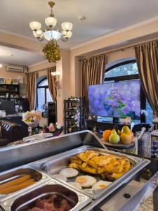 a buffet with eggs and fruit on a table at Pensiunea Toscana in Braşov