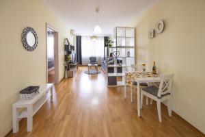 a living room with a white table and chairs at Apartment Sunflower021 in Novi Sad