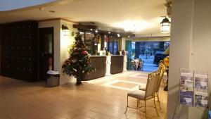 a christmas tree in the middle of a lobby at DM Residente Hotel Inns & Villas in Angeles
