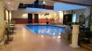 a large swimming pool in a large room at DM Residente Hotel Inns & Villas in Angeles