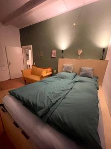 a bedroom with a large bed and a couch at Das "Alte Jagdhaus" - mit großem Grundstück für 3 Personen in Groß Garz