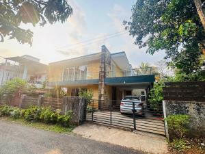 a house with a car parked in front of it at Peaceful Hideaway Ponda in Priol