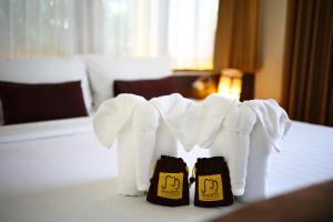 a pair of white towels sitting on top of a table at Hotel M Chiang Mai in Chiang Mai +21 photos