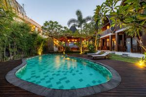 a swimming pool in the backyard of a house at Cove Dadeka in Canggu