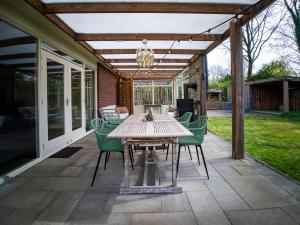 a patio with a table and chairs on it at Kamille | 4 persons in Gasselte