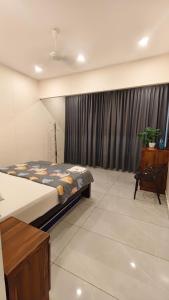 a bedroom with a bed and a window with curtains at Hill valley farm resort in Munnar