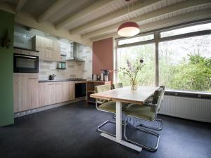 a kitchen with a table and chairs and a window at Kamille | 4 persons in Gasselte +26 photos