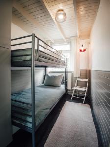 a room with two bunk beds and a chair at Kamille | 4 persons in Gasselte