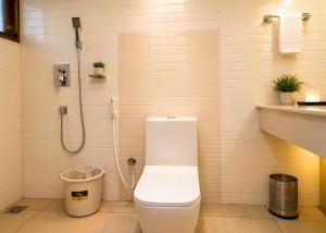a bathroom with a toilet and a shower at The Regatta Landing in Alleppey