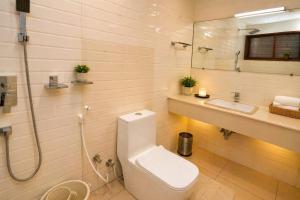 a bathroom with a toilet and a sink and a shower at The Regatta Landing in Alleppey