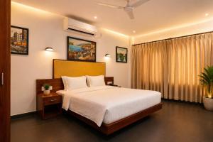 a bedroom with a large bed and a window at The Regatta Landing in Alleppey